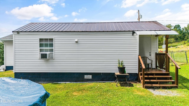 view of home's exterior with a yard and cooling unit