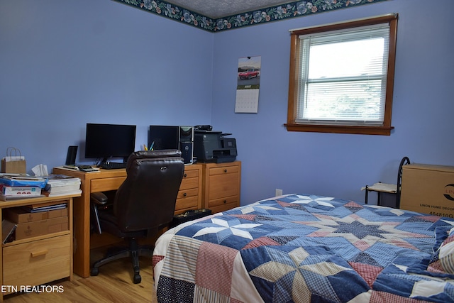 bedroom with light wood-type flooring