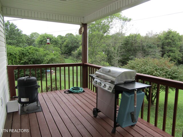 deck with grilling area and a lawn