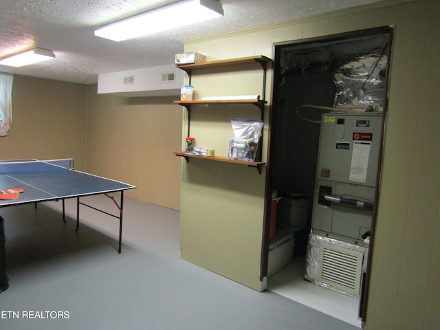 recreation room featuring visible vents, concrete flooring, and a textured ceiling