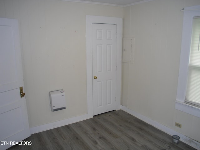 laundry room with crown molding and dark wood-type flooring