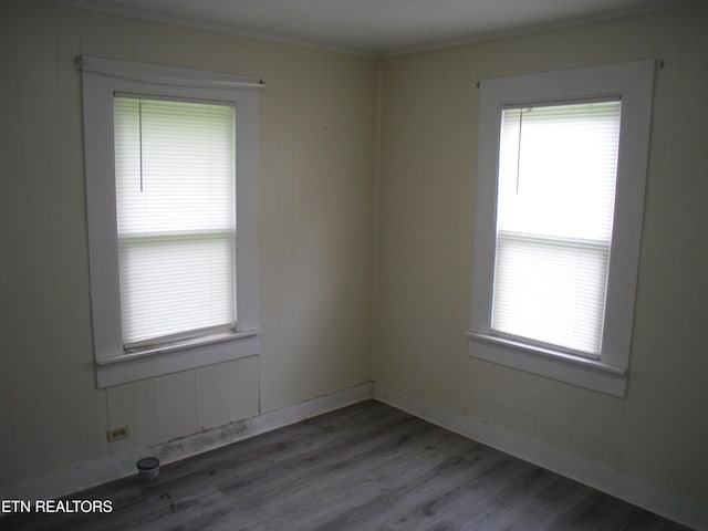 unfurnished room with hardwood / wood-style flooring