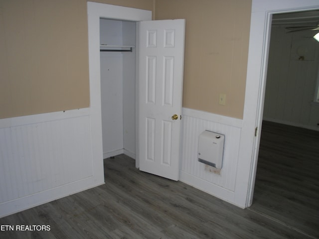 unfurnished bedroom with a closet and dark hardwood / wood-style flooring