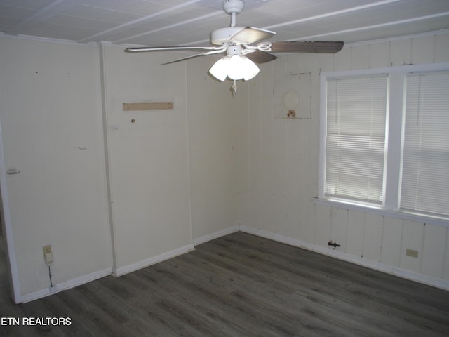 unfurnished room with ceiling fan and dark hardwood / wood-style flooring