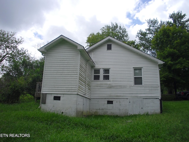 view of side of property with a yard