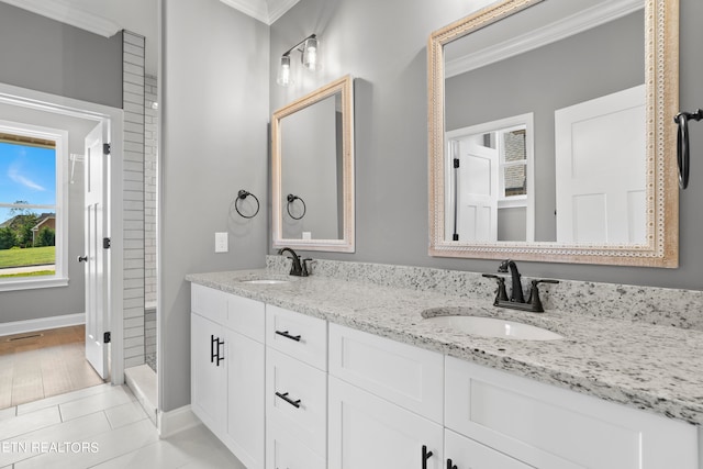 bathroom featuring vanity, crown molding, and tile patterned floors