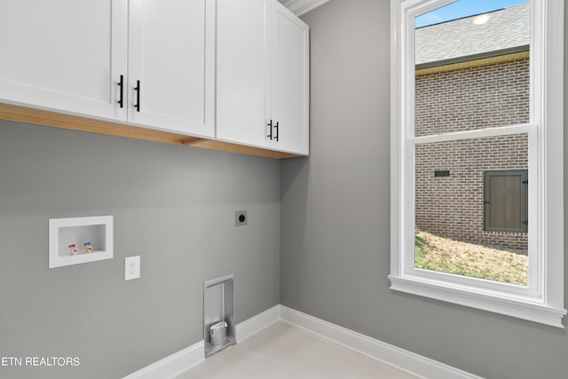 washroom with cabinets, hookup for an electric dryer, and washer hookup