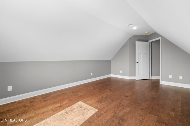 additional living space featuring vaulted ceiling and wood-type flooring