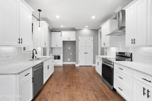 kitchen with light stone countertops, dark wood-type flooring, sink, wall chimney exhaust hood, and stainless steel appliances