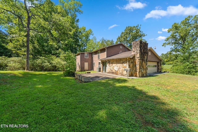 view of side of home featuring a garage and a yard