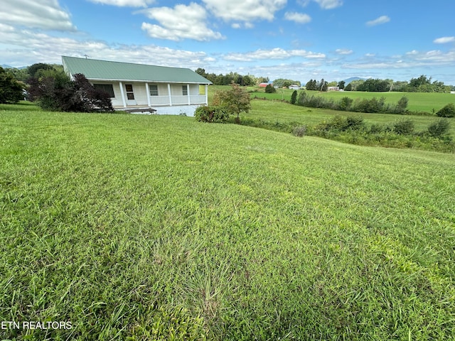 view of yard with a rural view