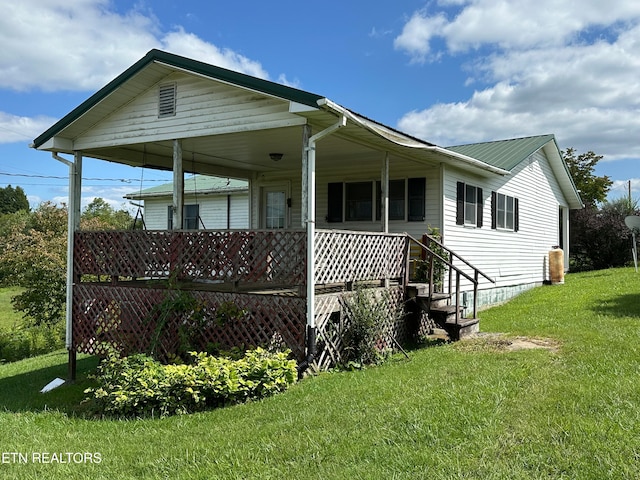 exterior space featuring covered porch and a front lawn