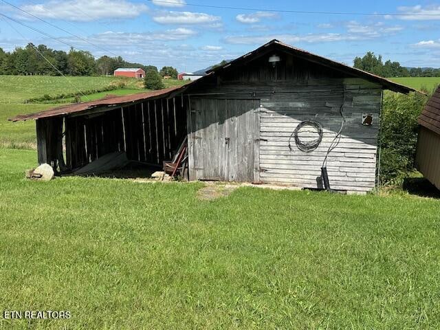 view of outbuilding with a yard