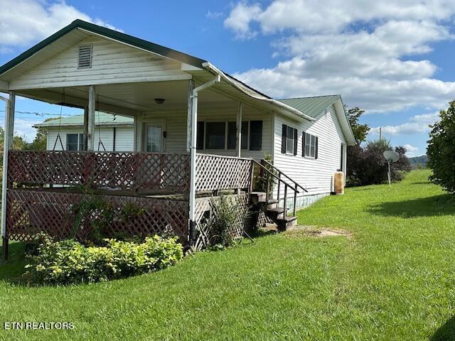 view of home's exterior with a lawn