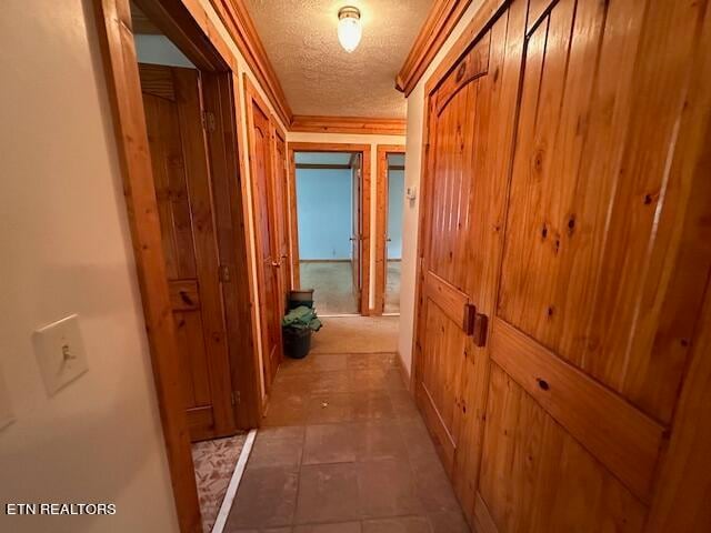 corridor featuring a textured ceiling