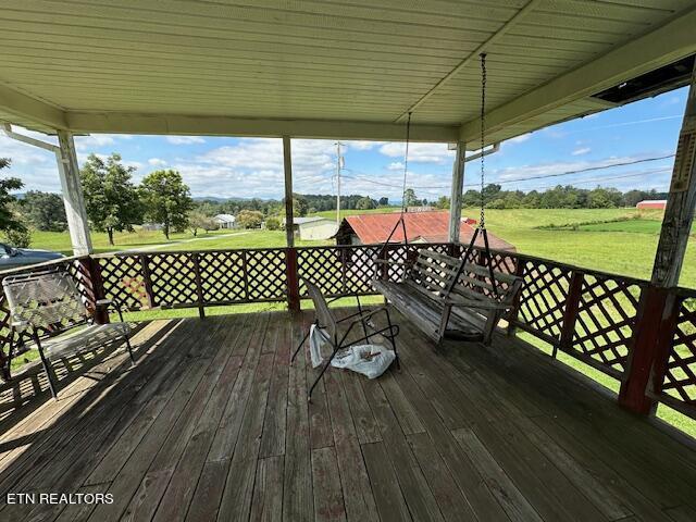 wooden deck with a lawn