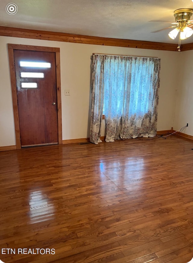 foyer entrance featuring ceiling fan, hardwood / wood-style flooring, and ornamental molding