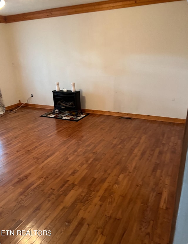 interior space featuring a wood stove and dark hardwood / wood-style floors