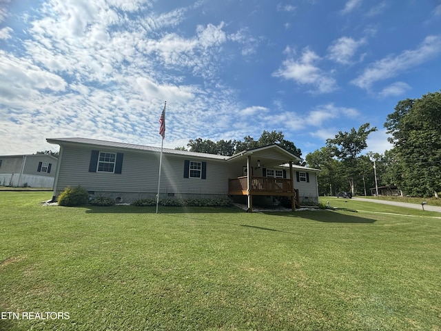 back of house with a deck and a lawn