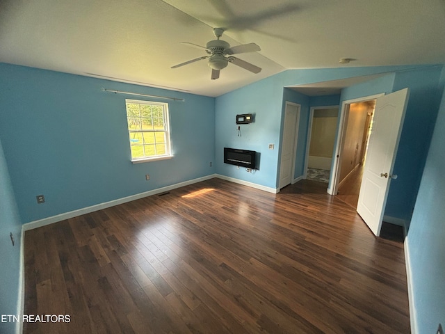 interior space with lofted ceiling, ceiling fan, dark hardwood / wood-style floors, and heating unit