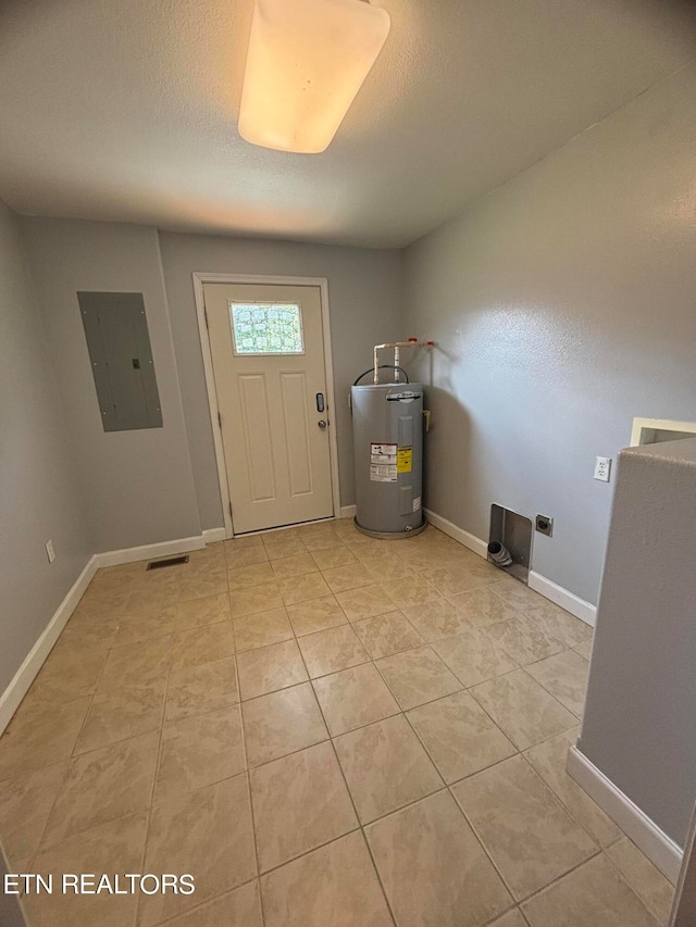 tiled foyer with electric panel, water heater, and a textured ceiling