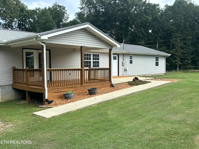 single story home with a front lawn and a wooden deck