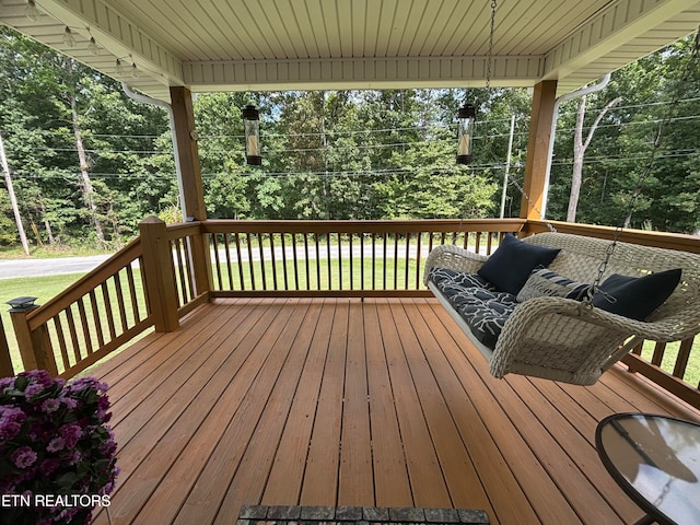 wooden deck featuring a yard