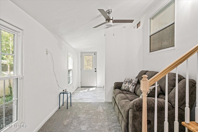 carpeted living room featuring ceiling fan