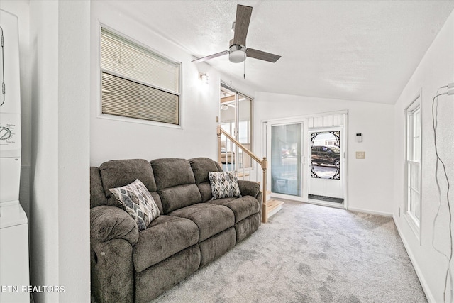 living room with light carpet, lofted ceiling, ceiling fan, and a textured ceiling