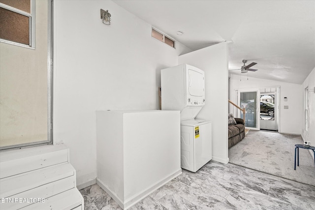 interior space featuring ceiling fan, light tile patterned floors, stacked washing maching and dryer, and a healthy amount of sunlight