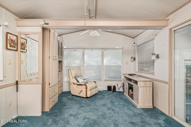 sitting room featuring carpet, ceiling fan, and lofted ceiling with beams