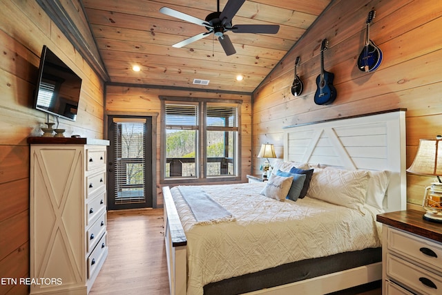 bedroom featuring light hardwood / wood-style flooring, vaulted ceiling, wooden walls, ceiling fan, and wood ceiling