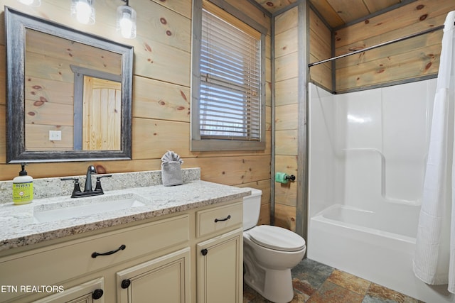 full bathroom with wood walls, vanity, tile patterned flooring, toilet, and shower / bath combo