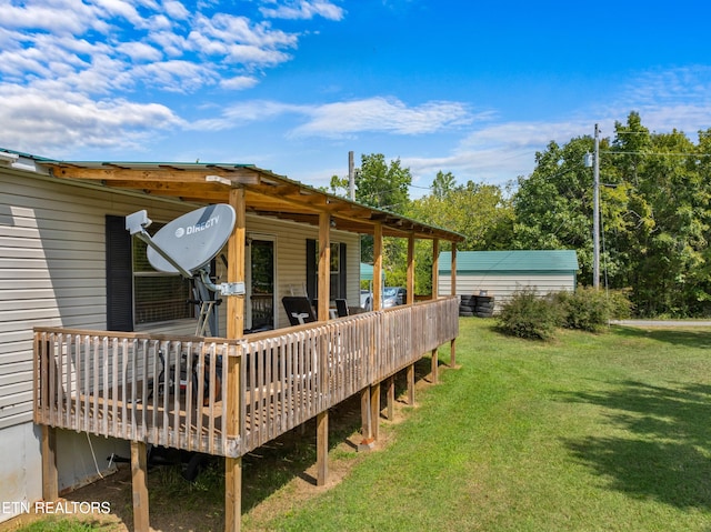 wooden deck featuring a lawn