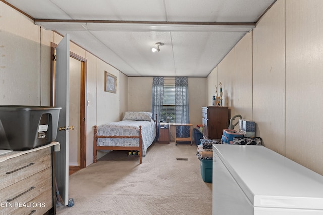 bedroom with refrigerator, carpet, a textured ceiling, and wood walls