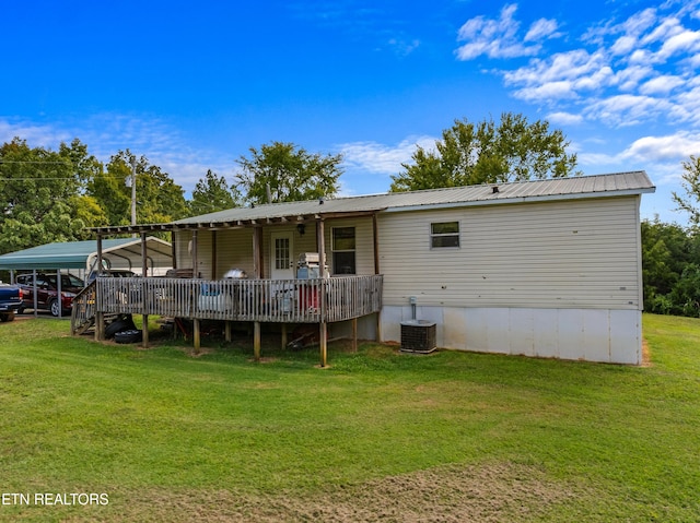 back of house with a wooden deck, a lawn, and cooling unit