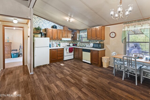 kitchen featuring a wealth of natural light, white appliances, vaulted ceiling, and dark hardwood / wood-style floors