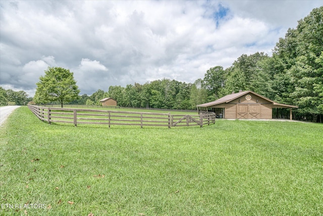 view of yard featuring a rural view and an outbuilding