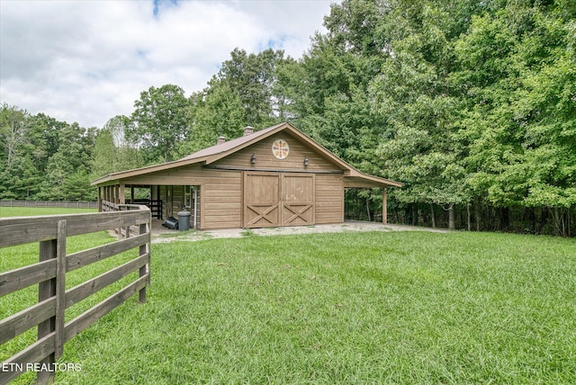 exterior space featuring an outbuilding and a front yard