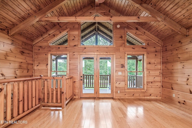 doorway to outside with beam ceiling, light hardwood / wood-style flooring, and a healthy amount of sunlight