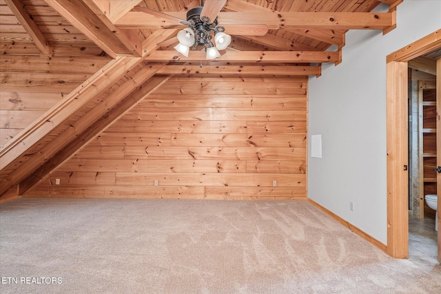 additional living space featuring wooden ceiling, lofted ceiling with beams, ceiling fan, and light carpet