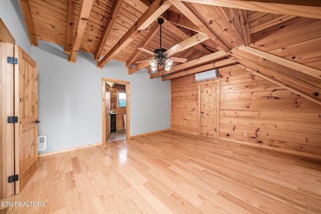 additional living space featuring ceiling fan, light hardwood / wood-style flooring, wooden walls, wooden ceiling, and a wall mounted air conditioner