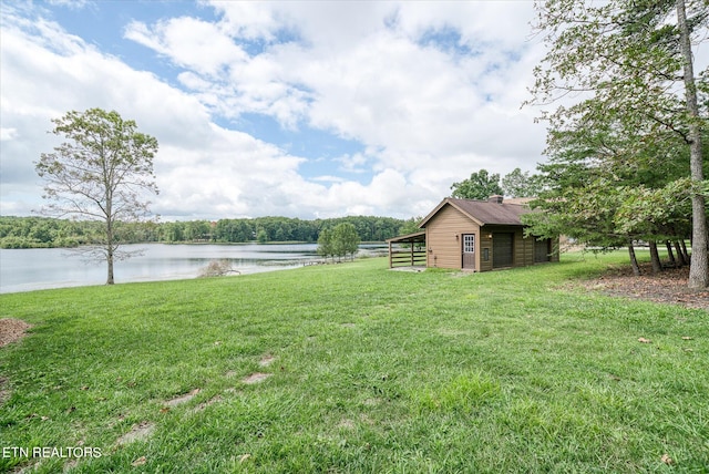 view of yard featuring an outbuilding and a water view