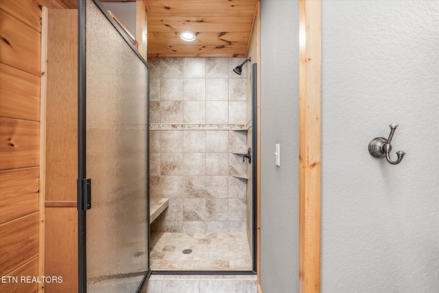 bathroom with walk in shower and wooden ceiling