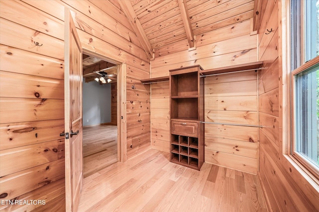 walk in closet featuring ceiling fan, light hardwood / wood-style flooring, and vaulted ceiling