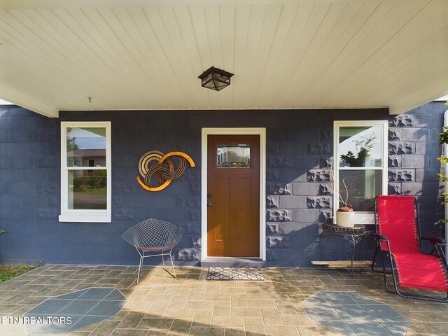 view of exterior entry featuring a patio