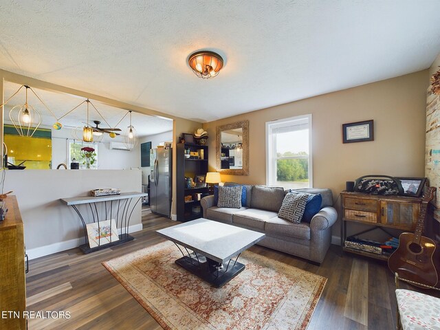 living room featuring a textured ceiling and dark hardwood / wood-style floors