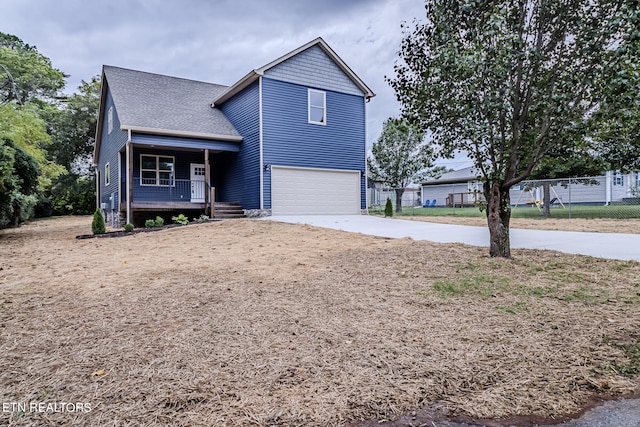 view of property featuring a garage and a porch