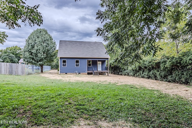 back of house featuring a yard