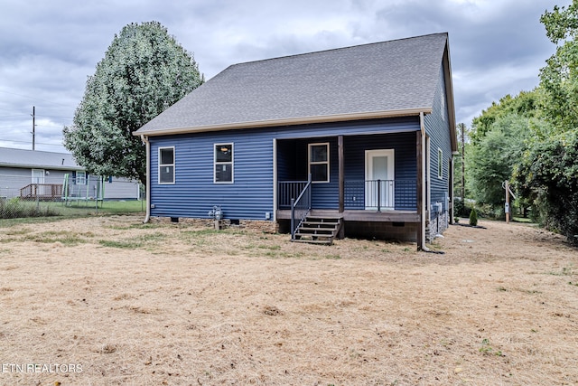 view of front of property featuring covered porch and a trampoline